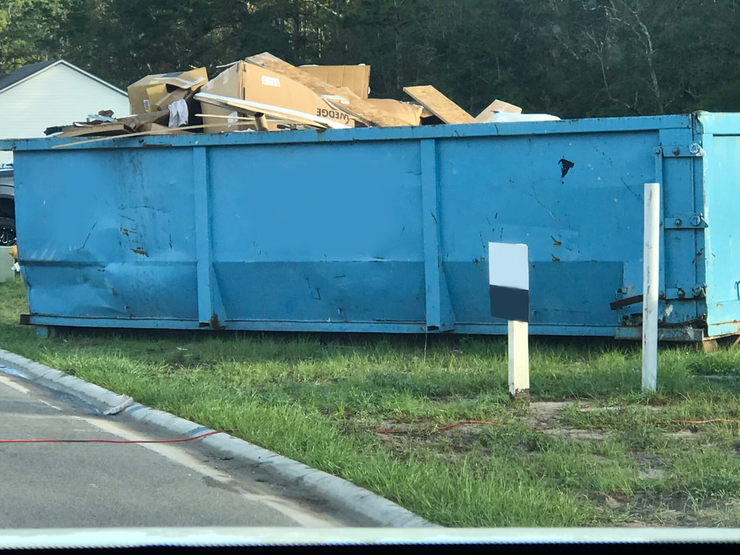 large roll off dumpster getting dropped off in Lakeland, FL